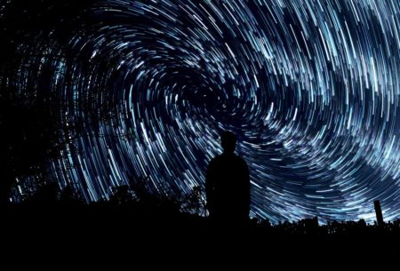 an anxious man seeing turbulence in the starry night sky